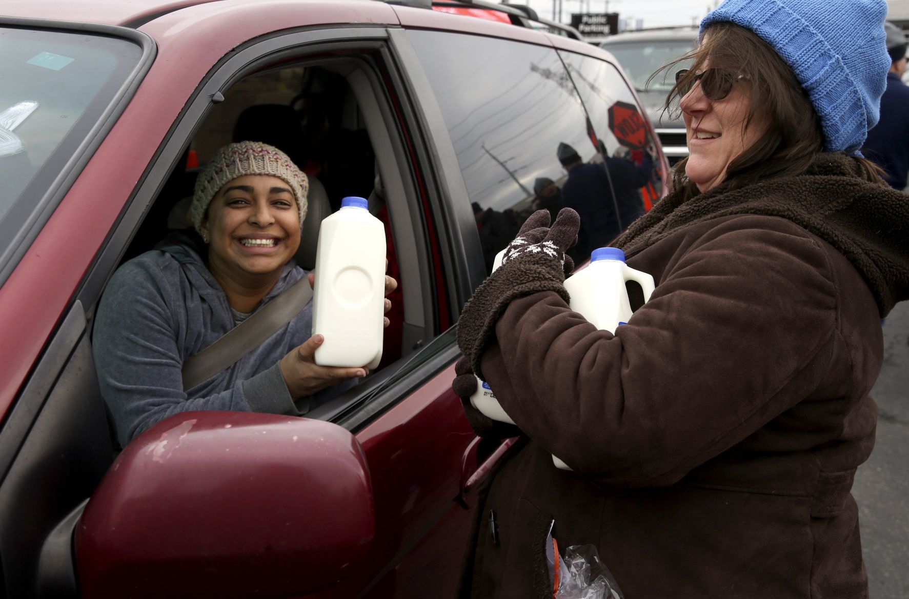 Handing out items during 'Thanksgiving Together' food giveaway